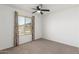 This cozy bedroom features neutral carpeting and a ceiling fan for added comfort at 9801 N 56Th Dr, Glendale, AZ 85302