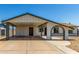 Exterior view showing the house featuring a covered carport and well-maintained desert landscaping at 9801 N 56Th Dr, Glendale, AZ 85302