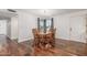 Elegant dining room with hardwood floors, stylish light fixture, and a view to the front yard at 9801 N 56Th Dr, Glendale, AZ 85302