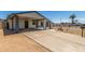 Spacious driveway with a covered carport, leading to an inviting home exterior and desert landscaping at 9801 N 56Th Dr, Glendale, AZ 85302
