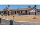 Charming single-story home featuring a desert landscape, carport, and a freshly painted exterior at 9801 N 56Th Dr, Glendale, AZ 85302