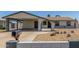 Charming single-story home with a covered carport, xeriscaped yard and painted decorative block wall at 9801 N 56Th Dr, Glendale, AZ 85302