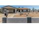 Charming single-story home with a covered carport, xeriscaped yard and painted decorative block wall at 9801 N 56Th Dr, Glendale, AZ 85302