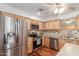 An updated kitchen features stainless steel appliances and wooden cabinets at 9801 N 56Th Dr, Glendale, AZ 85302