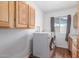 A conveniently located laundry room offers storage cabinets, washer and dryer, plus natural light at 9801 N 56Th Dr, Glendale, AZ 85302