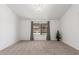 Spacious living room with plush carpeting, lots of natural light and a view of the front yard at 9801 N 56Th Dr, Glendale, AZ 85302