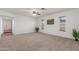 This bright living room features neutral carpeting and multiple windows for natural light at 9801 N 56Th Dr, Glendale, AZ 85302