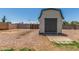Storage shed featuring rock ground cover, a block fence, and is easily accessible at 9801 N 56Th Dr, Glendale, AZ 85302