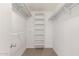Walk-in closet featuring built-in shelving and ample storage space at 9801 N 56Th Dr, Glendale, AZ 85302
