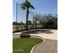 Landscaped backyard features a pool, patio, and lush greenery at 1038 S Palomino Creek Dr, Gilbert, AZ 85296