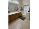 Bright bathroom featuring double sinks, a large mirror, and a soaking tub at 1038 S Palomino Creek Dr, Gilbert, AZ 85296