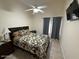Comfortable bedroom with ceiling fan, TV, and a queen-sized bed with floral comforter at 1038 S Palomino Creek Dr, Gilbert, AZ 85296