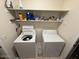 Laundry room featuring full-sized washing machine and dryer with storage shelving at 1038 S Palomino Creek Dr, Gilbert, AZ 85296