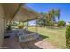 Covered back patio with outdoor seating, overlooking a well-maintained yard at 10702 W Salem Dr, Sun City, AZ 85351