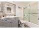 Bathroom featuring grey vanity, shower over tub with textured glass door, and neutral finishes at 10702 W Salem Dr, Sun City, AZ 85351