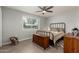 Bedroom with neutral walls, ceiling fan, wood-look tile flooring, and a charming woven rocking chair at 10702 W Salem Dr, Sun City, AZ 85351