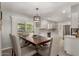 Dining area showcasing a spacious table, modern lighting, and easy access to the kitchen at 10702 W Salem Dr, Sun City, AZ 85351
