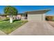 Charming single-story home with a two-car garage, manicured lawn, and neatly landscaped front yard at 10702 W Salem Dr, Sun City, AZ 85351