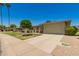 Well-maintained single-story home with a neatly landscaped front yard and spacious two-car garage at 10702 W Salem Dr, Sun City, AZ 85351