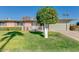 Attractive single-story home with a well-manicured lawn, a two-car garage, and a neatly landscaped front yard at 10702 W Salem Dr, Sun City, AZ 85351