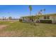 Charming single-story home with covered patio, lush green lawn, and mature trees in a desirable community at 10702 W Salem Dr, Sun City, AZ 85351