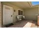 Inviting covered front porch with seating, neutral tones, and well-kept landscaping at 10702 W Salem Dr, Sun City, AZ 85351