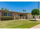 Charming single-story home with manicured lawn, flowering shrubbery, and a tidy two-car garage at 10702 W Salem Dr, Sun City, AZ 85351