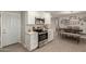 Bright kitchen features white cabinets, stainless steel appliances, and an open layout to the dining area at 10702 W Salem Dr, Sun City, AZ 85351