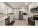 Updated kitchen with stainless steel appliances, white cabinets, and elegant backsplash at 10702 W Salem Dr, Sun City, AZ 85351
