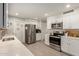 Modern kitchen featuring stainless steel appliances and white cabinets at 10702 W Salem Dr, Sun City, AZ 85351