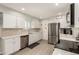 Bright kitchen with white cabinets, stainless steel appliances, and stylish backsplash at 10702 W Salem Dr, Sun City, AZ 85351