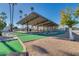 Entertaining mini-golf course with lush landscaping and shaded seating areas at 10702 W Salem Dr, Sun City, AZ 85351