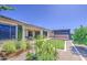 Landscaped backyard featuring a garden, pergola, manicured lawn, gravel, and a covered patio area perfect for outdoor entertaining at 10715 E Thornton Ave, Mesa, AZ 85212