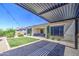 Backyard with large pergola, string lights, patio and a well manicured lawn at 10715 E Thornton Ave, Mesa, AZ 85212