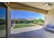 Backyard features a covered patio and a well maintained green lawn at 10715 E Thornton Ave, Mesa, AZ 85212