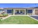 Green backyard and covered patio, with modern landscape and string lights at 10715 E Thornton Ave, Mesa, AZ 85212