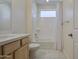 Bright bathroom featuring a shower-tub combo, a white vanity, and tile floors at 10715 E Thornton Ave, Mesa, AZ 85212