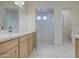 Bathroom with double vanity, contemporary lighting, and glass enclosed shower at 10715 E Thornton Ave, Mesa, AZ 85212