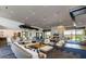 The common room boasts an open layout with fireplace, ample seating, and natural light at 10715 E Thornton Ave, Mesa, AZ 85212