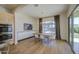 Open concept dining room with modern lighting, large windows and backyard view at 10715 E Thornton Ave, Mesa, AZ 85212