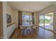 Bright dining room with hardwood floors, contemporary light fixture and large windows at 10715 E Thornton Ave, Mesa, AZ 85212