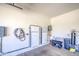 Clean garage featuring Tesla Powerwall, water softener and storage shelves at 10715 E Thornton Ave, Mesa, AZ 85212