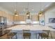Bright gourmet kitchen featuring a large island with quartz countertops, and pendant lighting at 10715 E Thornton Ave, Mesa, AZ 85212