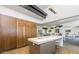 Gourmet kitchen with center island, sleek modern cabinets, and stainless steel appliances at 10715 E Thornton Ave, Mesa, AZ 85212