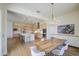 Large kitchen area with stainless steel appliances, custom cabinets, and adjoining dining area at 10715 E Thornton Ave, Mesa, AZ 85212