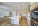 Open-concept kitchen with large island, pendant lighting, and stainless steel appliances at 10715 E Thornton Ave, Mesa, AZ 85212