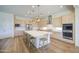 Spacious kitchen featuring a center island, stainless steel appliances, and custom cabinets at 10715 E Thornton Ave, Mesa, AZ 85212