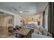 Comfortable living room with modern furnishings flowing into a gourmet kitchen with stainless steel appliances at 10715 E Thornton Ave, Mesa, AZ 85212
