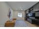 Comfortable living room with a leather sofa, built-in shelving, and a ceiling fan at 10715 E Thornton Ave, Mesa, AZ 85212
