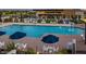 Stunning community pool area with plenty of lounge chairs and umbrellas at 10715 E Thornton Ave, Mesa, AZ 85212